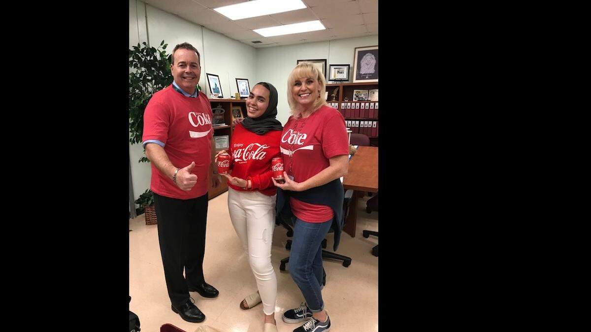 Aisha Chebbi from Coral Reef High School, center, was named a semifinalist in the 2020 class of the Coca-Cola Scholars Program. She is joined by Principal Thomas Ennis, left, and College Advisor Lou Gilman.