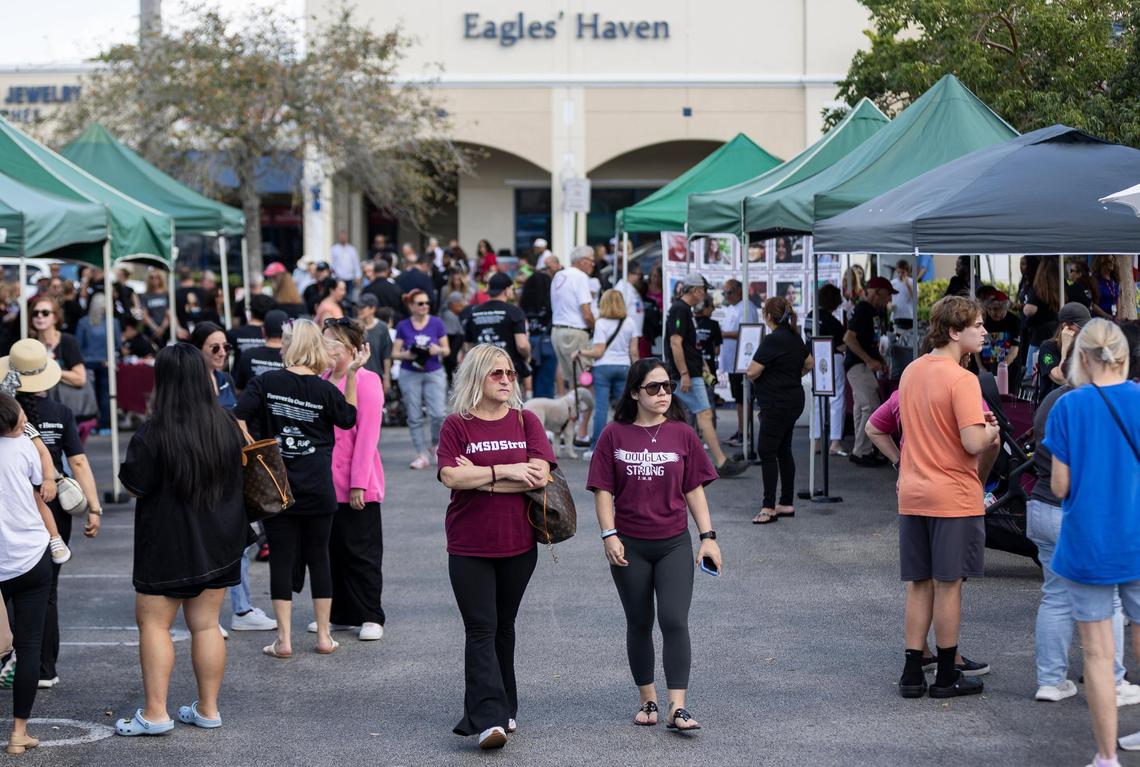 Lisa Nolasco, left, and Gillian Kramer attend the ‘Forever in Our Hearts’ commemoration event outside of the Eagles’ Haven Wellness Center on Friday, Feb. 14, 2025, in Coral Springs, Fla. The event aims to honor the 17 lives lost during the Marjory Stoneman Douglas High School shooting in 2018 and their families.