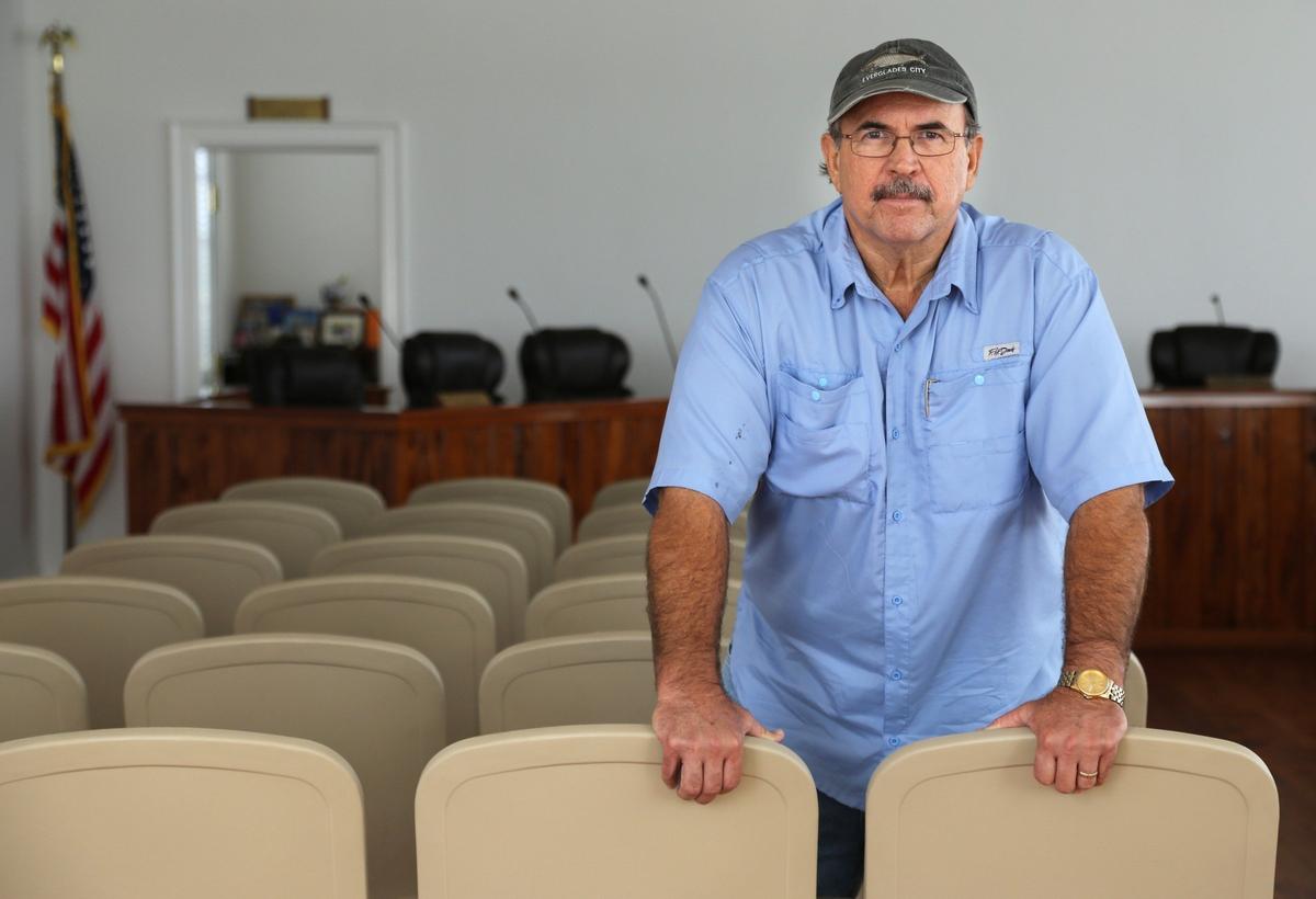 Everglades City Mayor Howie Grimm stands inside City Hall’s second floor chambers on Thursday. Irma pushed ashore a six-  to eight-foot muddy storm surge that buckled the floor, which was replaced. This month, the historic building should get a new coat of paint.