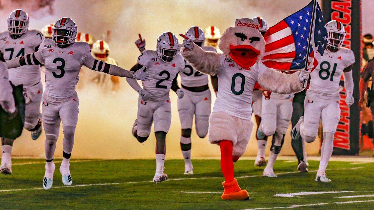 The Miami Hurricanes rush the field to start the game as the University of Miami host the Virginia Cavaliers at Hard Rock Stadium in Miami Gardens on Friday, October 11, 2019.