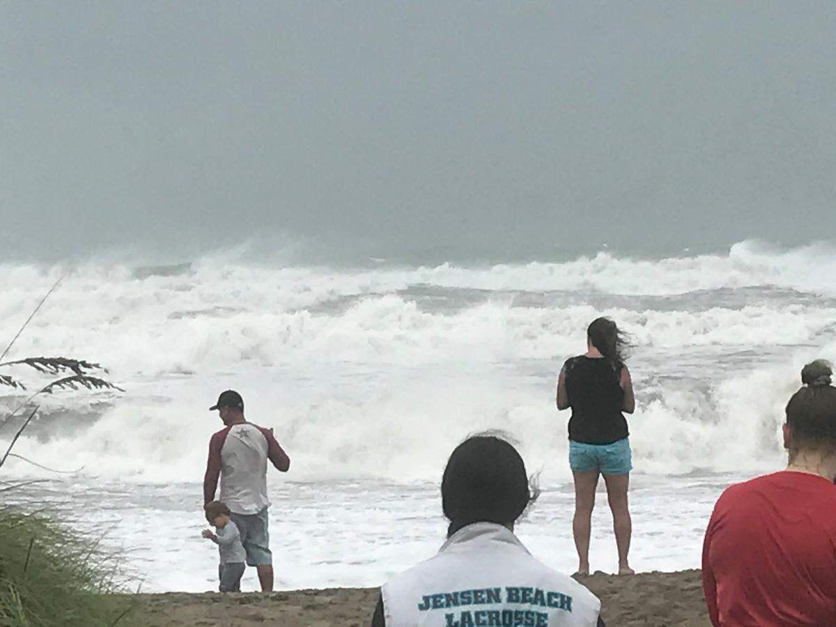 People gather on Jensen Beach Tuesday, Sept. 3, 2019, to watch the huge surf churned up by Hurricane Dorian.