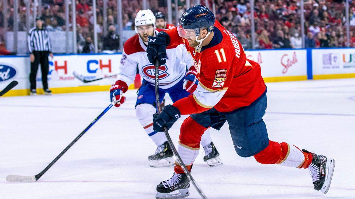 Florida Panthers center Jonathan Huberdeau (11) shoots the puck during the second period of an NHL game against the Montreal Canadiens at FLA Live Arena in Sunrise, Florida, on Saturday, January 1, 2022.