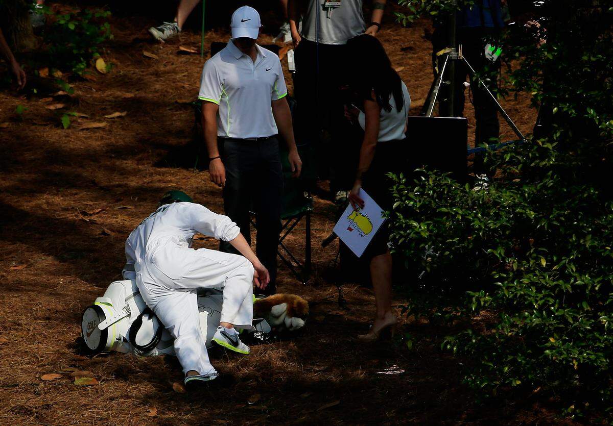 AUGUSTA, GA - APRIL 08: Rory McIlroy of Northern Ireland watches after his caddie Niall Horan of the band One Direction slipped on pine straw during the Par 3 Contest prior to the start of the 2015 Masters Tournament at Augusta National Golf Club on April 8, 2015 in Augusta, Georgia. (Photo by Jamie Squire/Getty Images)
