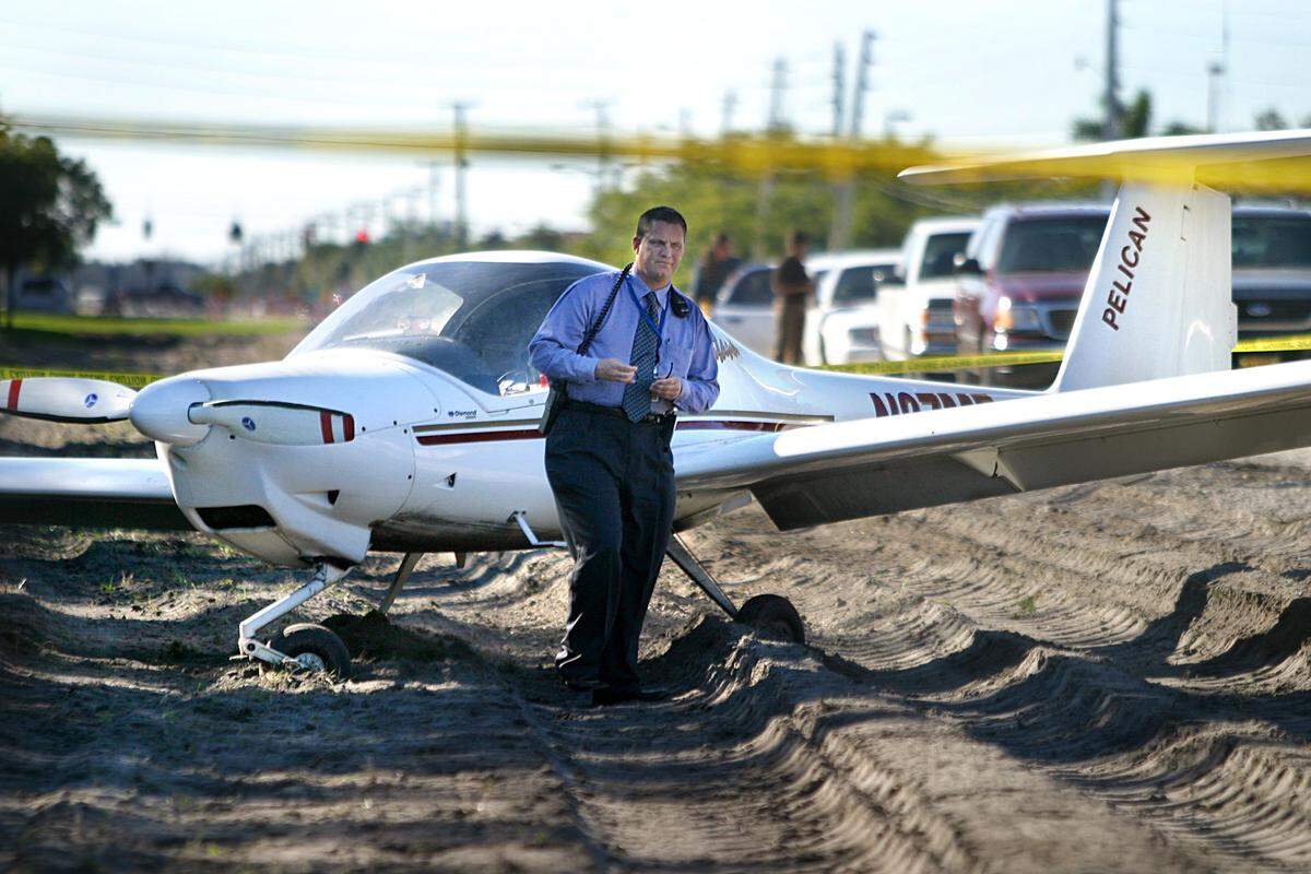 David Bezanis, operations supervisor for Hollywood-Fort Lauderdale International Airport, walks away after inspecting of a single-engine Katana DA 20 airplane on Jan. 6, 2003, following an emergency landing in a road construction site on the Miramar side of Pembroke Road near 118th Avenue. The plane, operated by pilot instructor Khareem Madden, 20, of Pelican Airways at North Perry Airport, and student John Hannan, 21, of Southwest Ranches, developed oil pressure problems while on a training flight over a practice area in West Broward. The men reported that on the way back to Perry Airport they lost oil pressure, smoke filled the cabin and the engine quit. Madden brought the plane down under power lines, followed the flow of traffic, bounced in the street at a break in traffic and turned the plane into the construction area.