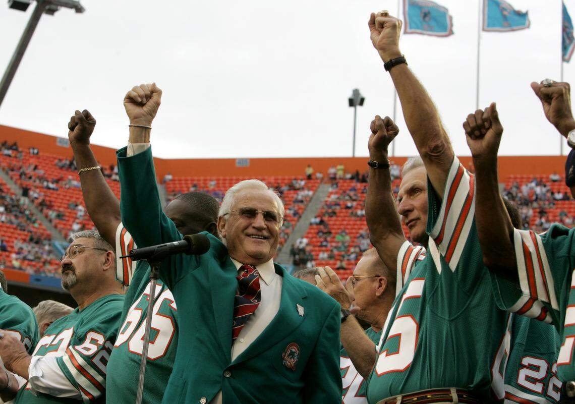 In this Dec. 16, 2007 file photo, former Miami Dolphins coach Don Shula, left, and player Nick Buoniconti, right, wave during a halftime ceremony honoring the 1972 perfect season of the Dolphins during an NFL football game against the Baltimore Ravens at Dolphin Stadium in Miami.