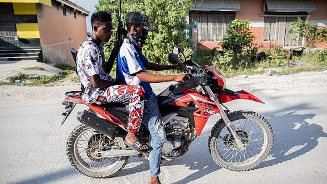 Armed gang members on a motorbike patrol the streets in the Mariani neighborhood of Port-au-Prince, Haiti, on October 6, 2025. Mariani is near the Route Nationale 2, parts of which have been taken over by gangs. More than 16,000 people have been killed in armed violence in Haiti since the start of 2022, the United Nations said on October 2, warning that "the worst may be yet to come". The poorest country in the Americas, Haiti has long suffered at the hands of violent criminal gangs that commit murders, rapes, looting, and kidnappings against a backdrop of chronic political instability. (Photo by Clarens SIFFROY / AFP) (Photo by CLARENS SIFFROY/AFP via Getty Images)          