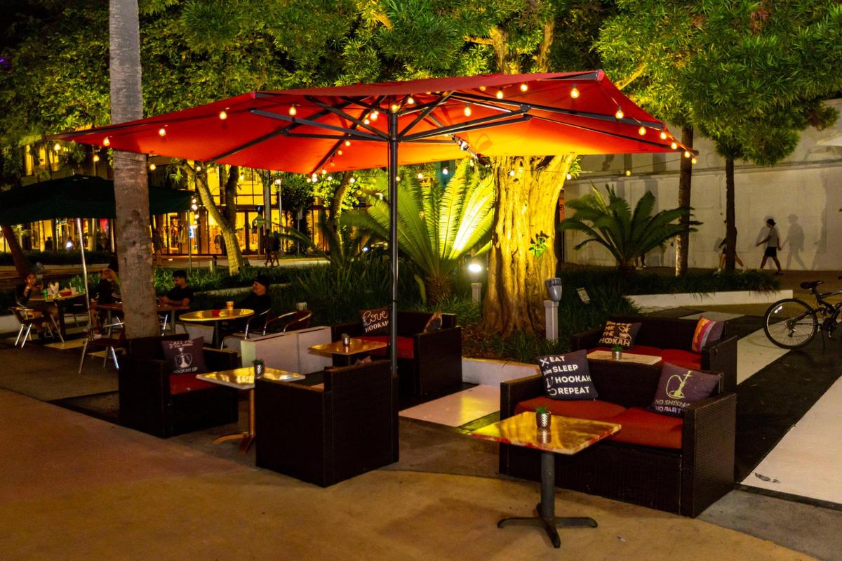 Booths and tables sit empty outside Groovy’s Hookah Bar on Lincoln Road on Thursday, Dec. 1, 2022. In October, Miami Beach implemented a new system to regulate sidewalk cafes that bans hookah on public property, meaning shops like Groovy’s can no longer serve it outdoors.