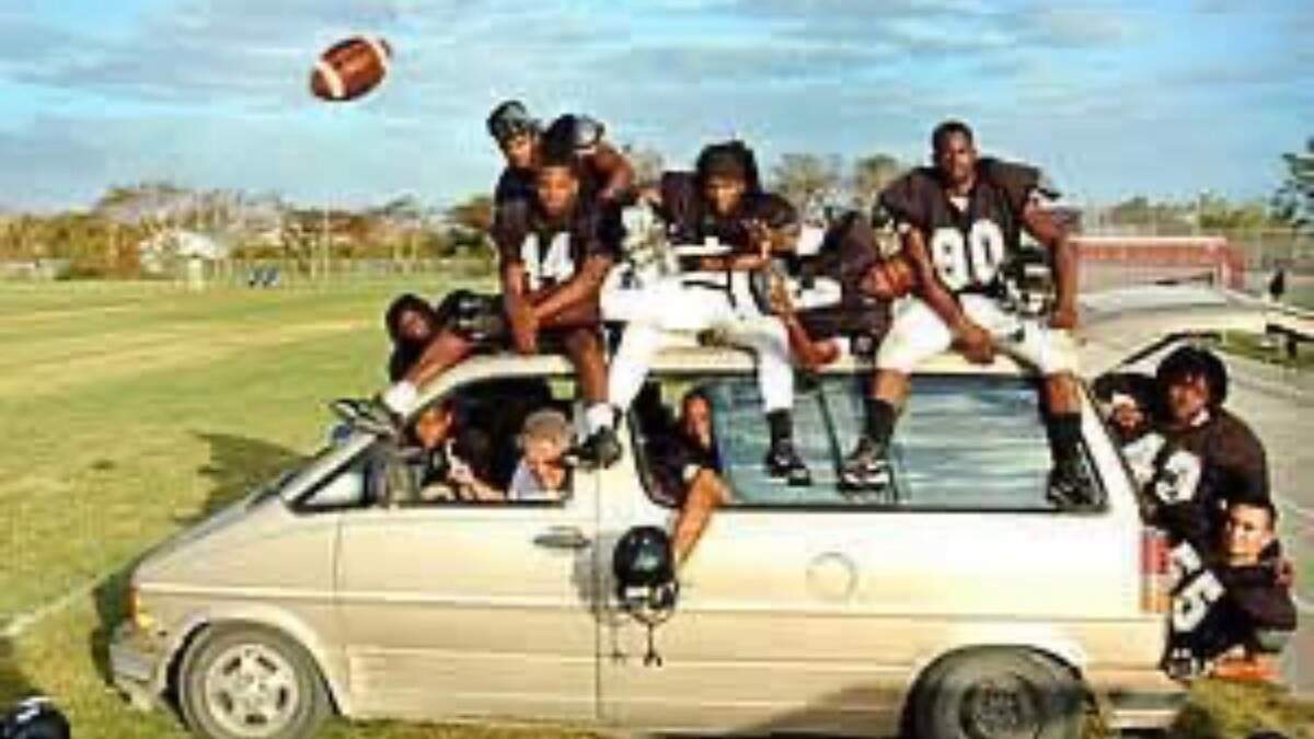 South Dade football players pile into Don Drinkhahn’s car during one of the coach’s famous “shuttle runs” through South Dade