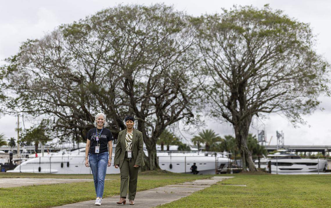 Elizabeth Fahy, the magnet coordinator and a marine science teacher, left, and Lezondra Harris, school principal, walk on the area where a potential new living shoreline may be built at New River Middle School on Thursday, Jan. 22, 2026, in Fort Lauderdale, Fla.