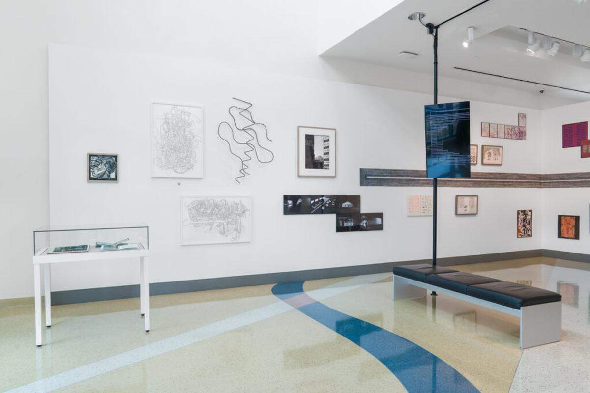 Installation view of “What’s My Line? Drawing as Experience” at the Miami Beach Regional Library, featuring works that expand drawing into sound, digital media, abstraction, and conceptual mapping.