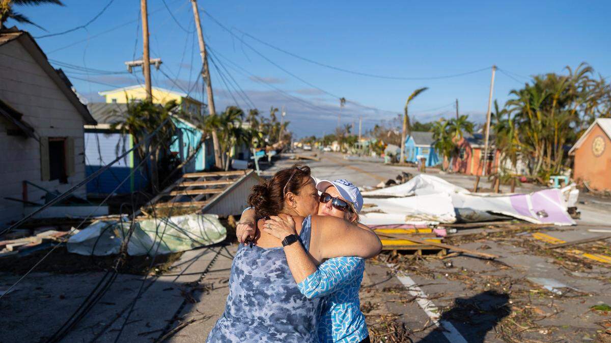 Donna LaMountain, 51, embraces her friend, Tammey Lynch, 55, among the damage left by Hurricane Ian on Sept. 29, 2022, in Matlacha. Ian made landfall on the coast of southwest Florida as a Cat 4 storm.
