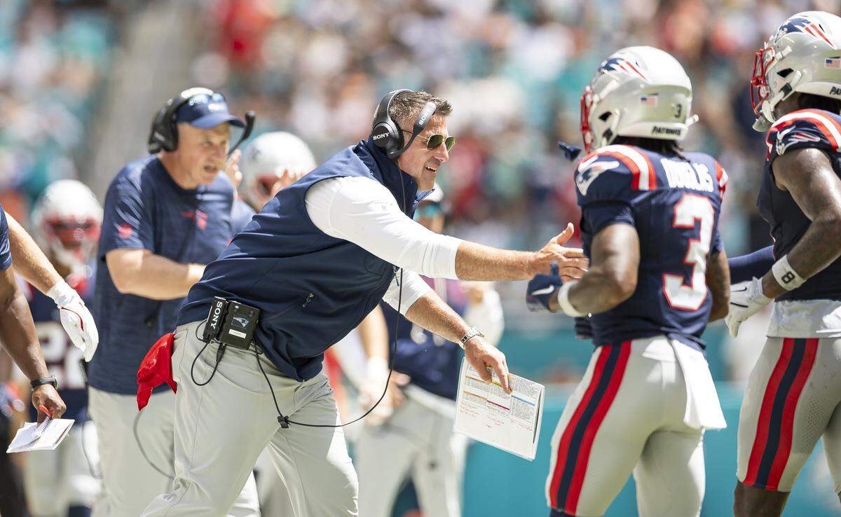 New England Patriots head coach Mike Vrabel reacts after his team scored against the Miami Dolphins in the first half of their NFL game at Hard Rock Stadium.