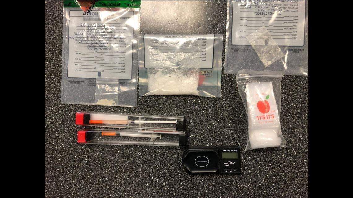 A Florida woman found a strange man on her patio at 7:15 a.m. and deputies discovered he was carting around meth, heroin and syringes, officials say.