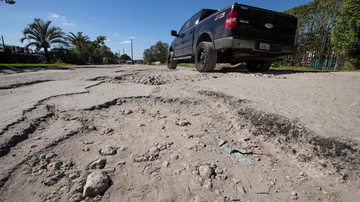 Business owners and employees in the area say potholed, torn-up Northwest 141st Street in Opa-locka is so difficult to navigate that customers are staying away from their businesses.