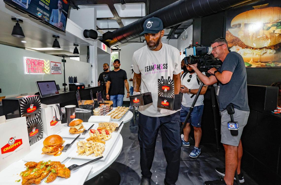 Former football player Randy Moss displays chicken dishes at his Crisppi’s Chicken franchise at 29th Street and Biscayne Boulevard in Miami, Florida, on Friday, July 11, 2025.