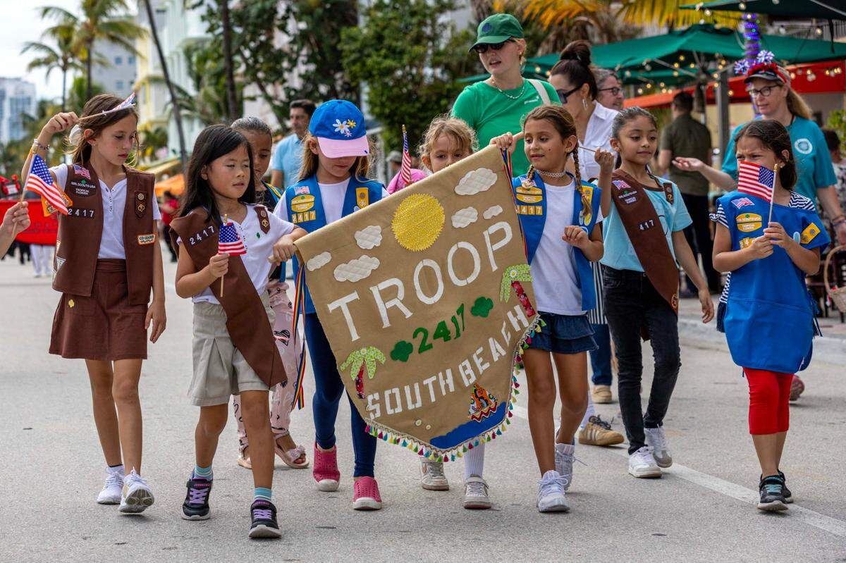 Members of the South Beach Girl Scout Troop 2417 march up Ocean Drive during the 16th Annual Veterans Day Parade on Monday, Nov. 11, 2024, in Miami Beach, Fla.