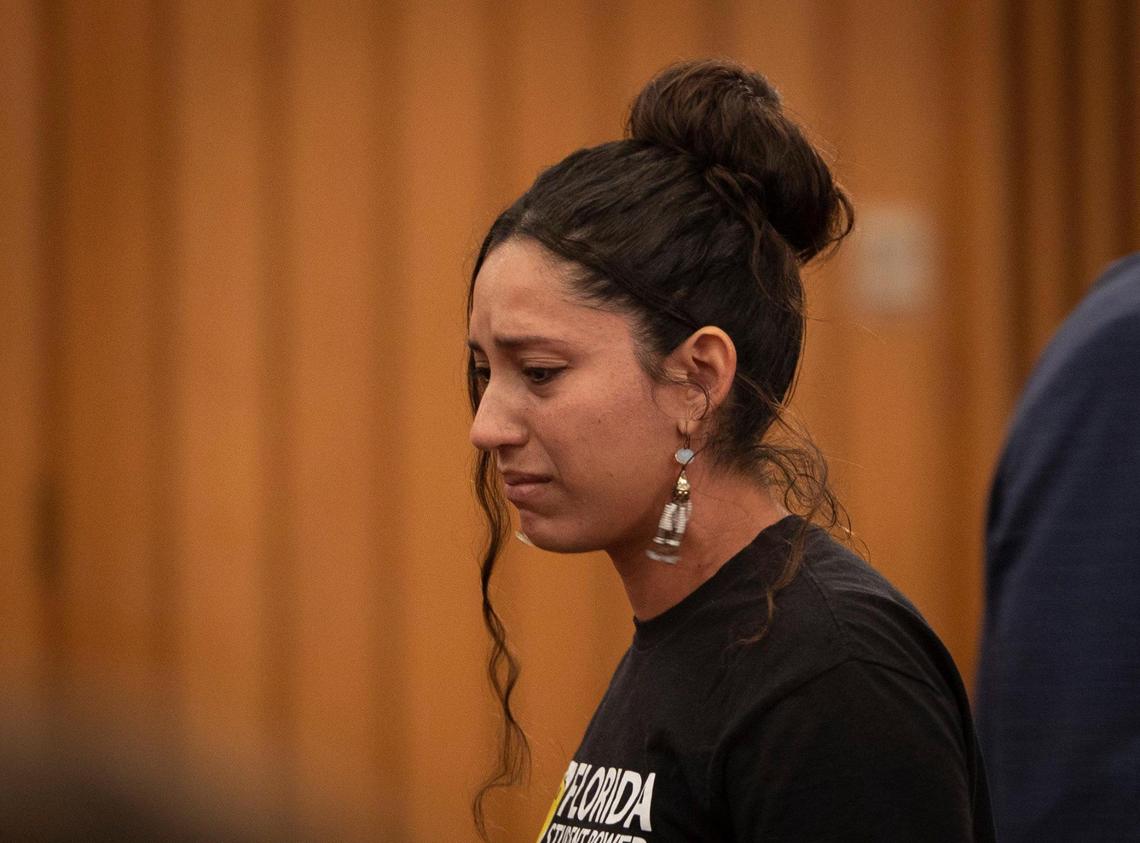A woman who spoke in support of the bill because her father died on the job walks back to her seat while crying during a Miami-Dade county commission Community Health Committee meeting on Monday, Sept. 11, 2023.