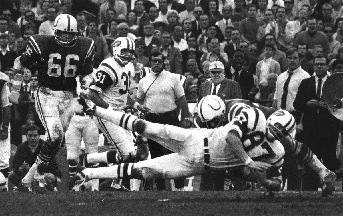 New York Jets defensive end Pete Lammons (87) stretched out horizontal and ready to hit the ground as he is hit by a Baltimore Colts defender in Super Bowl III from Miami Fla. in this Jan. 13, 1969 photo.