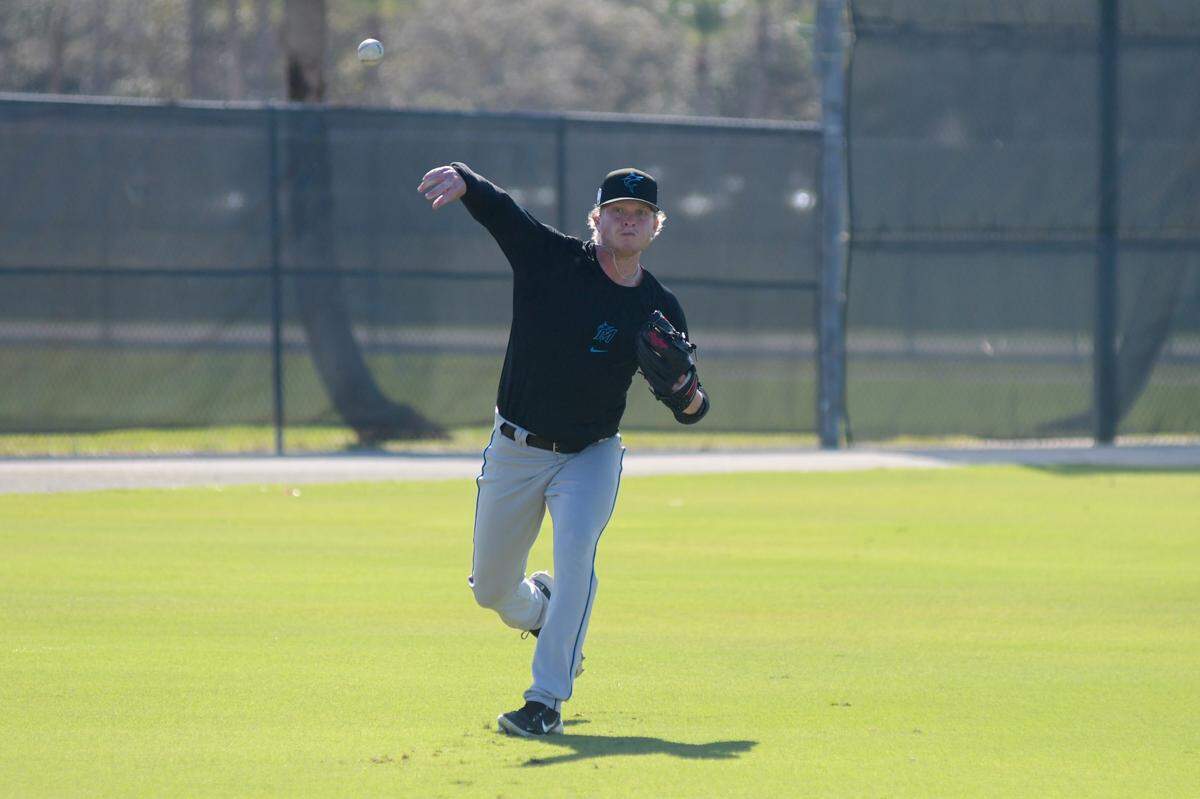 Miami Marlins right-handed pitcher Nic Enright plays catch on the back fields of the Roger Dean Chevrolet Stadium complex in Jupiter, Florida, on Tuesday, Feb. 14, 2023.