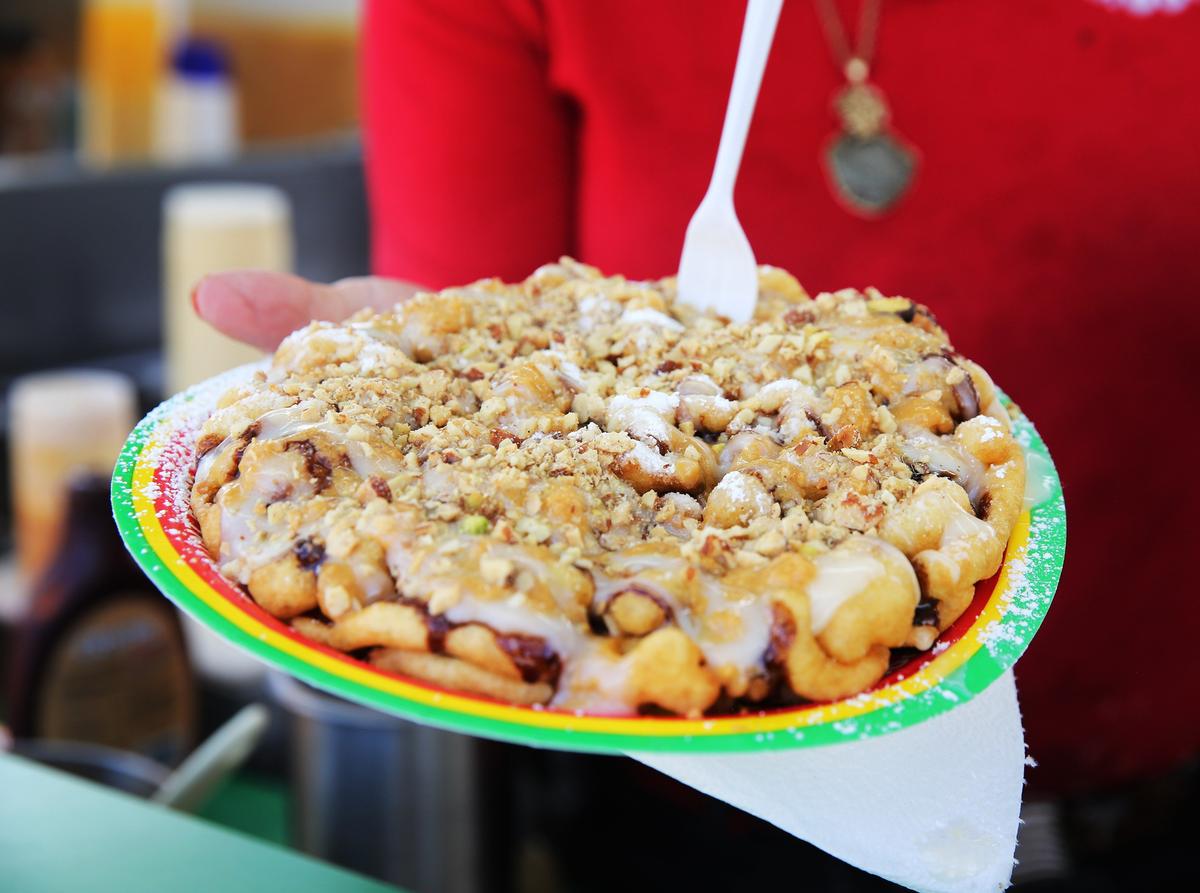 The Brazilian cheesecake funnel cake is drenched in dulce de leche, chocolate syrup, cream cheese icing and a mix of crushed nuts, such as pistachios, almonds, pecans and the aforementioned Brazil nuts. The funnel cake costs $9 and can be found at #246.
