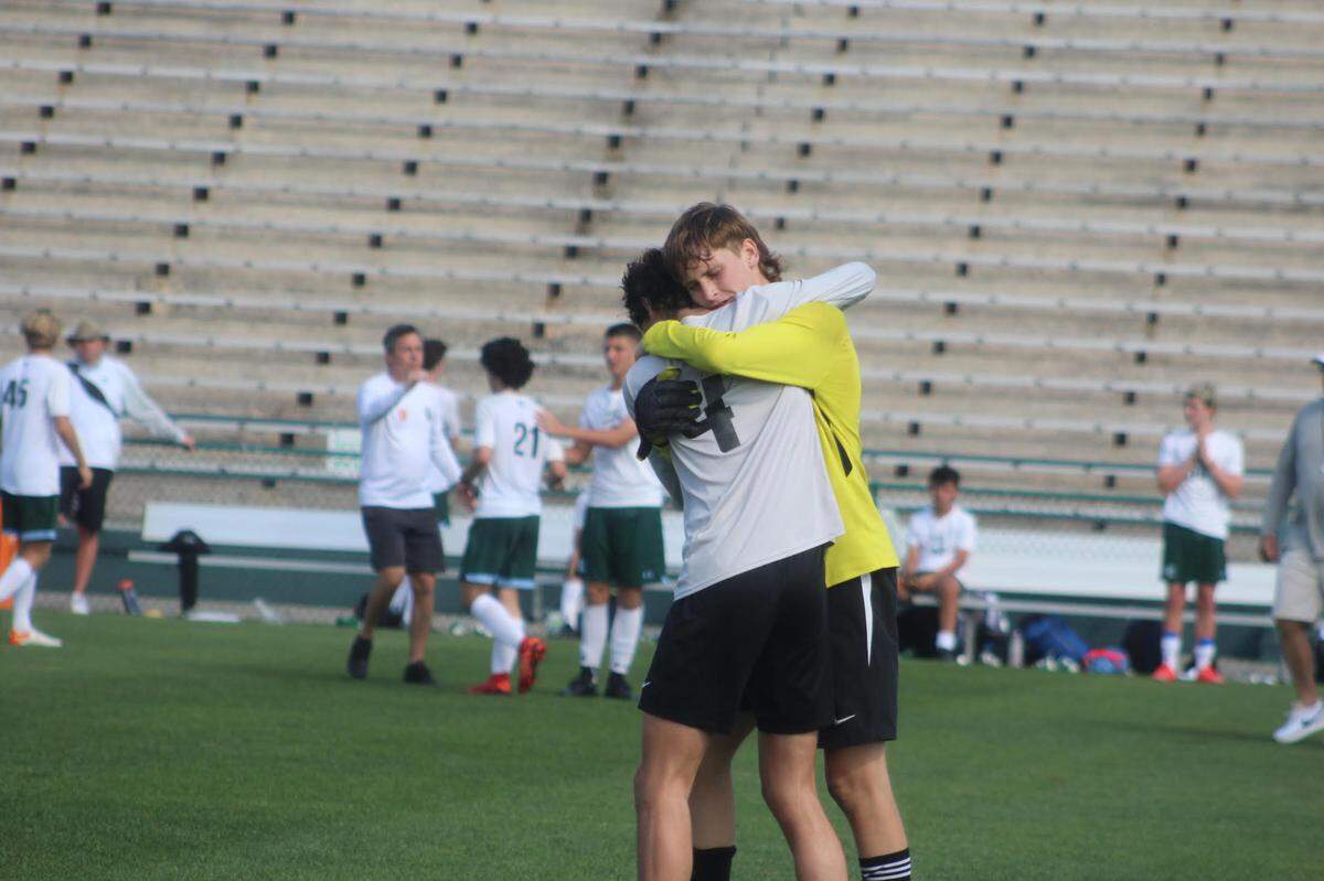 Ransom’s Ryan Sadler (4) consoles his goalkeeper Jasper Broad following the Raiders’ tough 2-0 loss to Tampa Prep in the 3A title game at Spec Martin Stadium in DeLand.