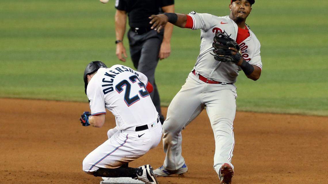 Miami Marlins Corey Dickerson (23) slides safely into second base as Philadelphia Phillies second baseman Jean Segura( 2) throws to first base in the eighth inning at loanDepotpark in Miami, Florida, May 26, 2021.