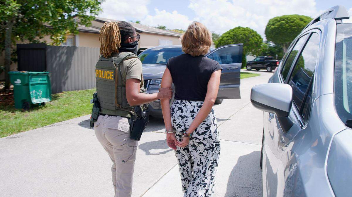 An Immigration and Customs Enforcement agent detains Adys Lastres Morera in Miami. Lastres Morera is the sister of Ania Guillermina Lastres Morera, the general who runs GAESA, the military conglomerate that runs most of Cuba’s economy.