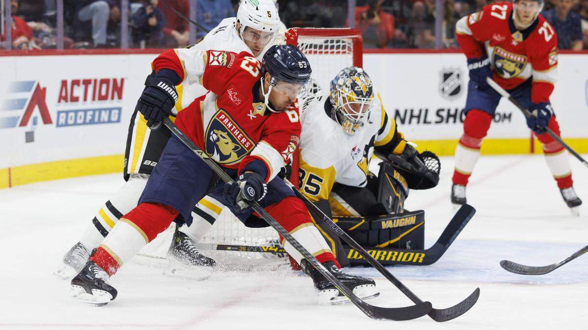 Florida Panthers left wing Brad Marchand (63) take a shot on goal that is blocked by Pittsburgh Penguins goaltender Tristan Jarry (35) during the first period of a game on Thursday, Oct. 23, 2025, at Amerant Bank Arena in Sunrise, Fla.