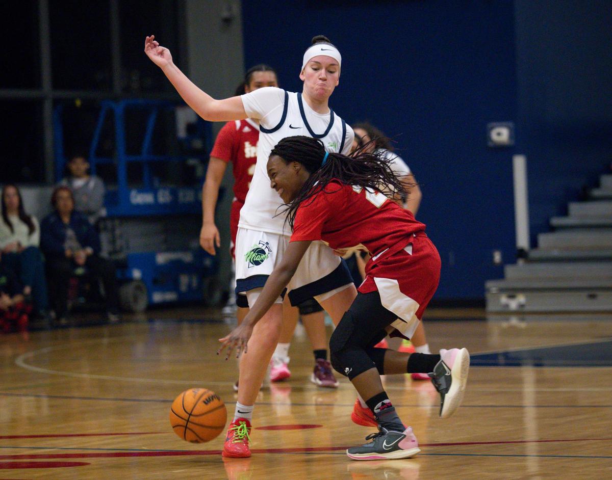 Monsignor Pace’s Catherine Guillaume (24) runs into SLAM’s Amanda Fogler (23) during the second quarter of the girls basketball regional semifinal between SLAM and Monsignor Pace on Monday, Feb. 19, 2024, at SLAM Miami.