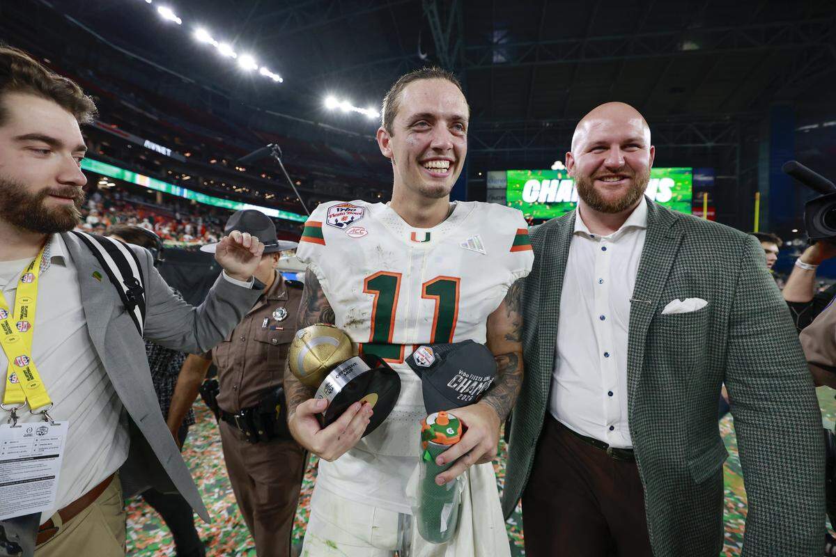 Miami Hurricanes quarterback Carson Beck (11) carries the Offensive MVP Trophy after defeating the Mississippi Rebels during the College Football Playoff semifinal at the Fiesta Bowl in State Farm Stadium on Friday, January 9, 2026 in Glendale, Arizona.