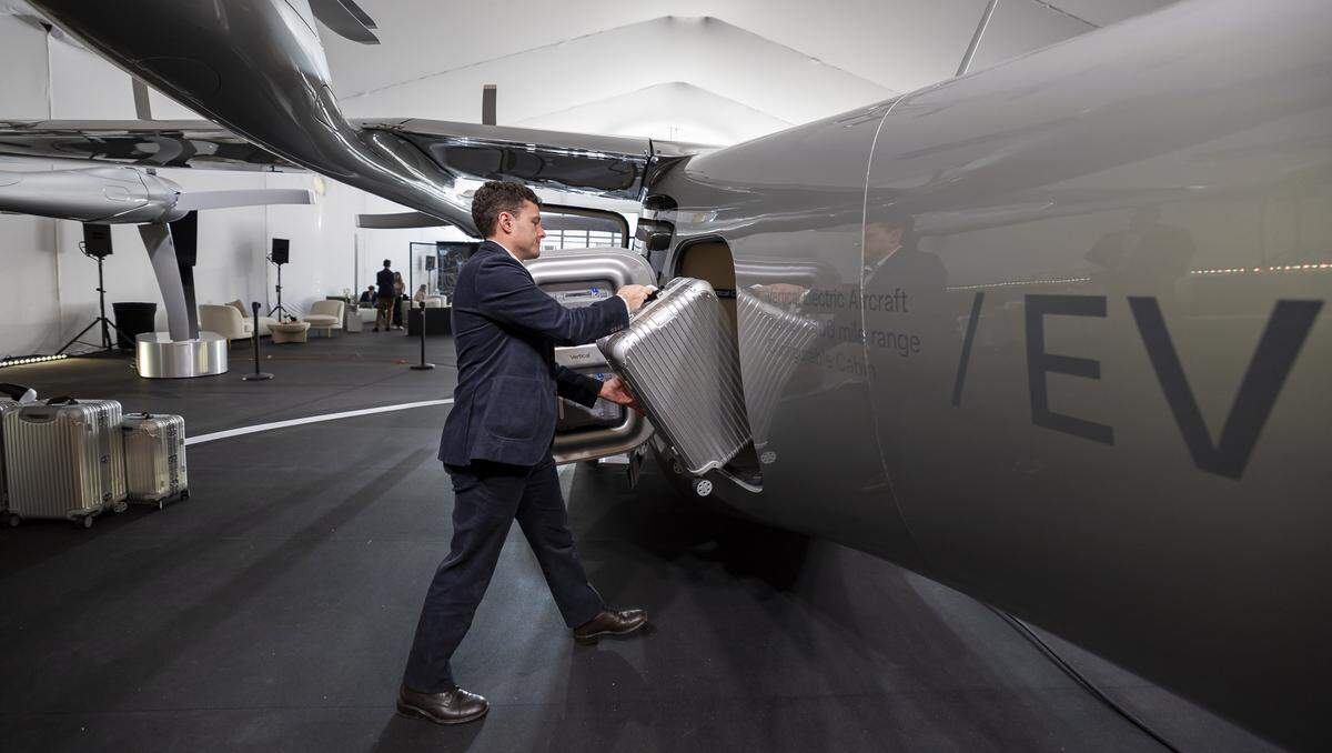 Josh Sams, 32, marketing and brand lead for Vertical Aerospace, demonstrates how the crew can load luggage into the company's Valo, a next-generation electric aircraft, during a public display event at Collins Park on Tuesday, Feb. 24, 2026, in Miami Beach, Fla. The aircraft can fly up to 100 miles at speeds of up to 150 mph, features a panoramic window, has cabin space for up to six passengers and uses all-electric propulsion. The company says passengers will be able to travel from Miami to Fort Lauderdale in about 13 minutes.