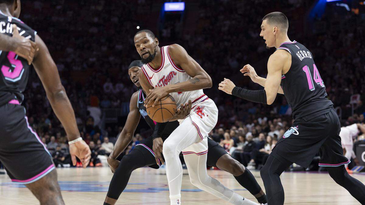 Houston Rockets forward Kevin Durant (7) works to control the ball as Miami Heat center Bam Adebayo (13) and guard Tyler Herro (14) defend in the first half of their NBA game at Kaseya Center on Feb. 28, 2026, in Miami.