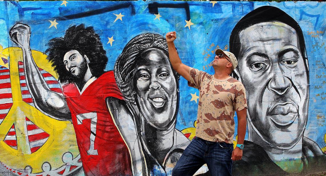 Artist Kyle Holbrook, muralist and activist best known for his street art in Pittsburgh, Pennsylvania and Miami, stands in front of his latest mural he painted in a wall at the intersection of 16th Street NW 1st Avenue in Overtown, to honor George Floyd, a 46-year-old black man, who died in Minneapolis, Minnesota after Derek Chauvin, a white police officer, pressed his knee to Floyd’s neck for almost nine minutes while Floyd was handcuffed face down in the street and Breonna Taylor, a 26-year-old EMT, who was shot to death in her apartment by Louisville Metro Police and also include player Colin Rand Kaepernick, as hundreds protested George Floyd death, on Wednesday, June 03, 2020.