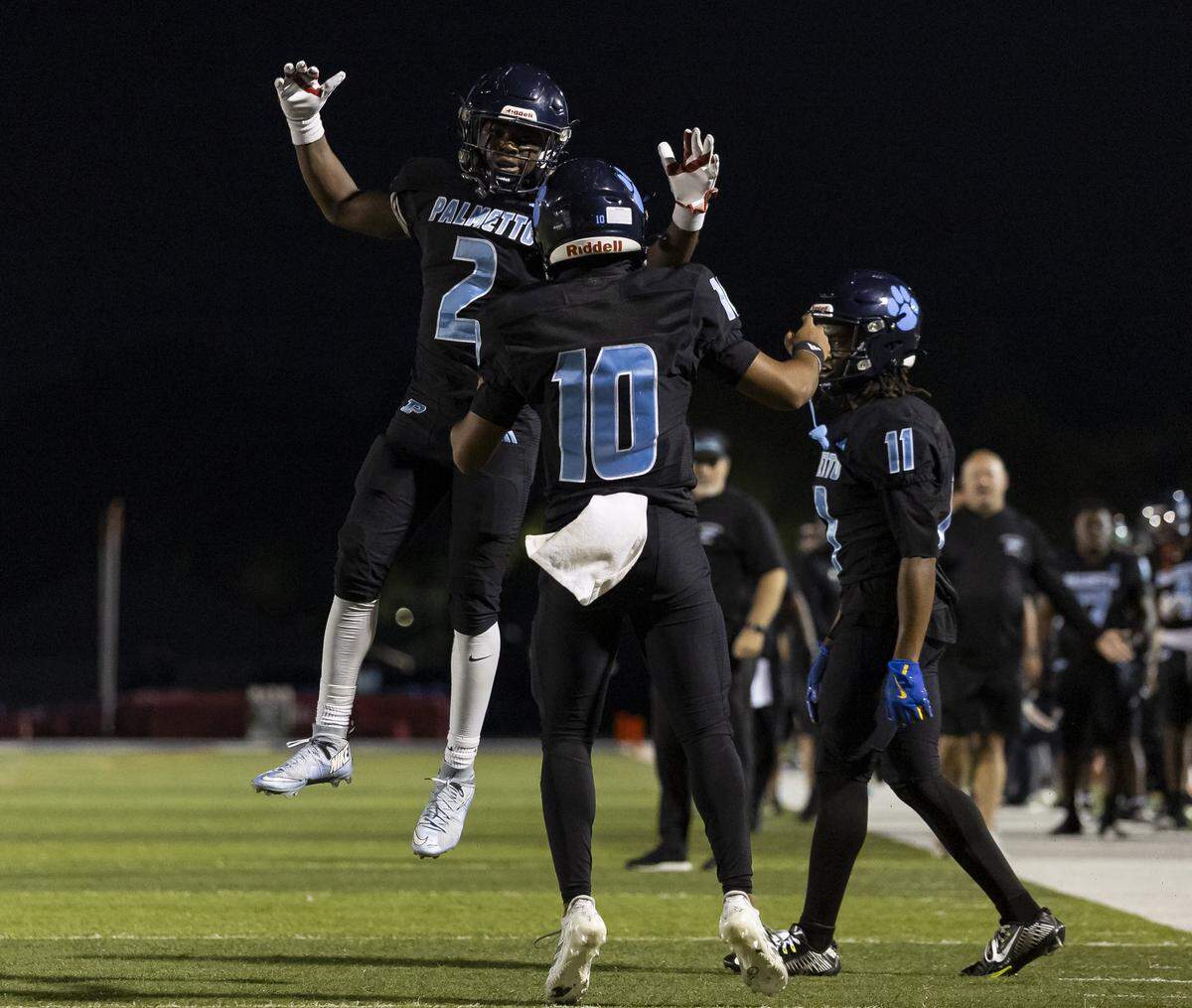 Palmetto Panthers running back Aiden Butler (2) and quarterback Andre Bailey (10) celebrate after scoring a touchdown against the Columbus Explorers in the first half of their Region 4-7A quarterfinal high school football playoff game at Tropical Park on Friday, Nov. 21, 2025, in Miami, Fla.