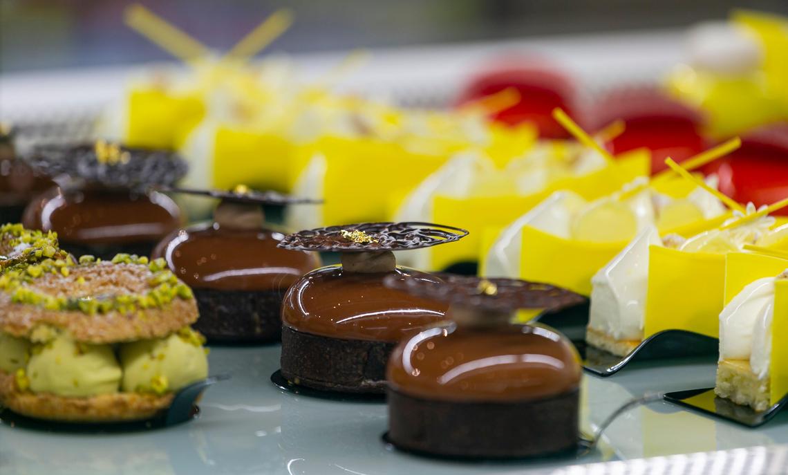 Pastry chef Antonio Bachour displays mirror glazed desserts at his bakery, Bachour, in Coral Gables, Florida on Tuesday, February 18, 2020. Bachour, who is regarded as the top pastry chef in the world, became an instagram sensation for his beautiful desserts with a shimmering colorful glaze.