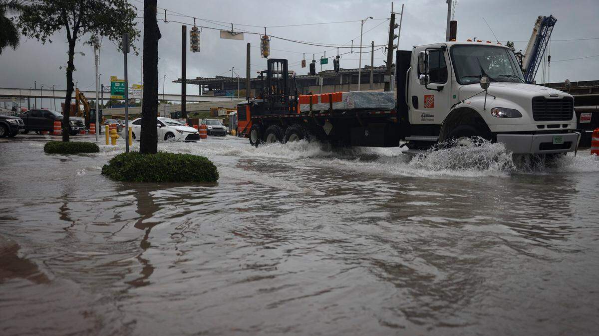 Exit 2 off of the MacArthur Causeway floods over the road and onto the sidewalk during a rain storm on Wednesday, April 12, 2023, in Miami.