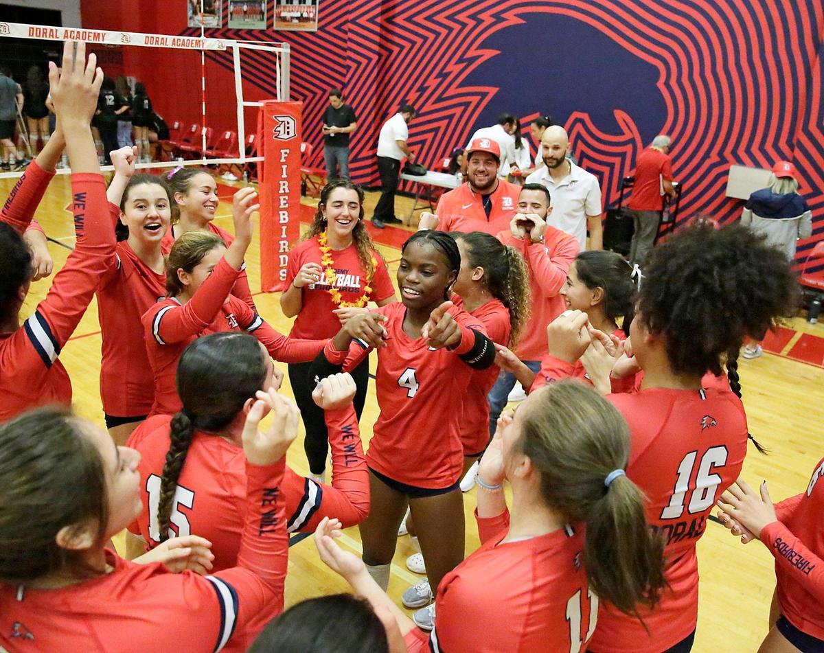 Doral Academy Firebirds players celebrate a victory against Ferguson Falcons during volleyball match on Saturday, October 29, 2022 at Doral Academy in Doral. Andrew Uloza / for Miami Herald
