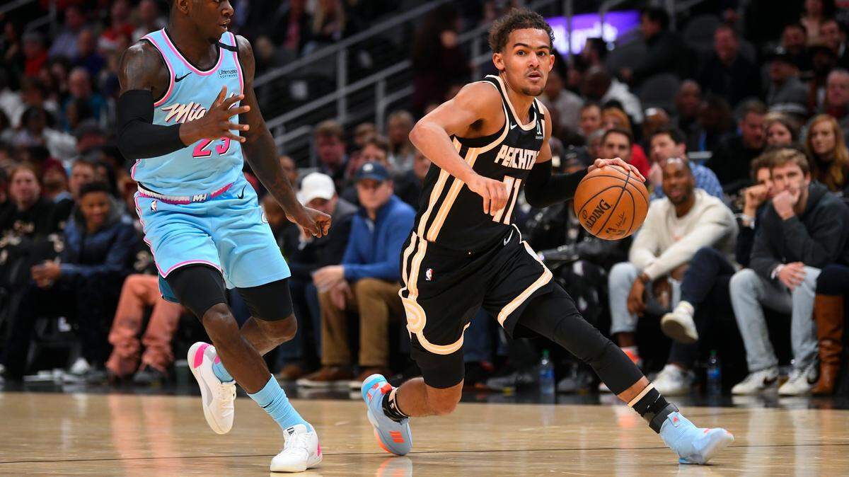 Atlanta Hawks guard Trae Young, front right, drives against Miami Heat guard Kendrick Nunn, left, during the first half of an NBA basketball game Thursday, Feb. 20, 2020, in Atlanta. (AP Photo/John Amis)