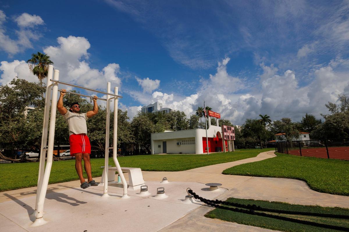 Joshua Castaneda works out at Flamingo Park, the green space and workout area shown being one of the proposed locations for a new Miami Beach Fire Station No. 1, on Wednesday, Aug. 7, 2024, in Miami Beach, Fla. If Flamingo Park is picked, it would be built along this side of the track on Alton Road. The track may need to be ripped up and the field house would have to be moved.