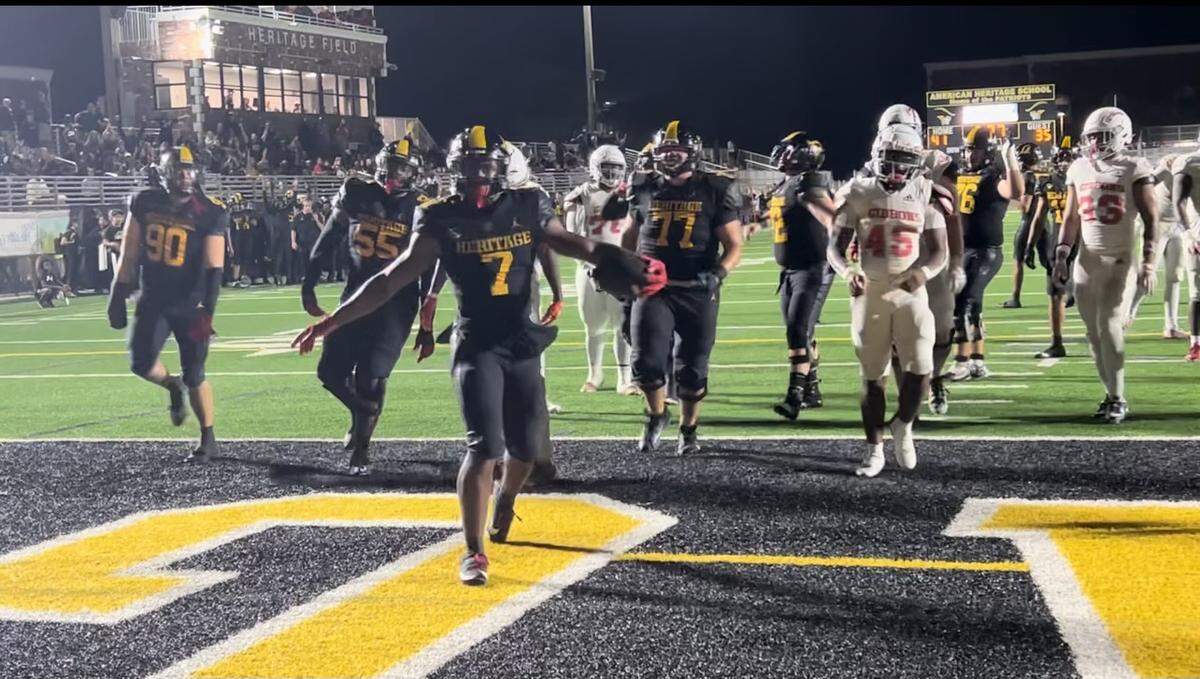 American Heritage running back Byron Louis celebrates after one of his five touchdowns in the Patriots’ victory Friday over Cardinal Gibbons in the Region 3-2M final at Heritage.