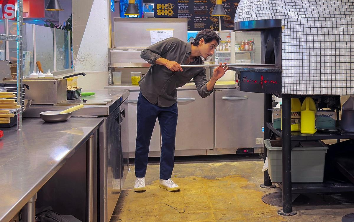Franco Stanzione at the wood-fired oven at his new pizzeria at The Citadel food hall. The restaurant serves authentic Neapolitan pizzas along with salads, wings, and chicken fingers.