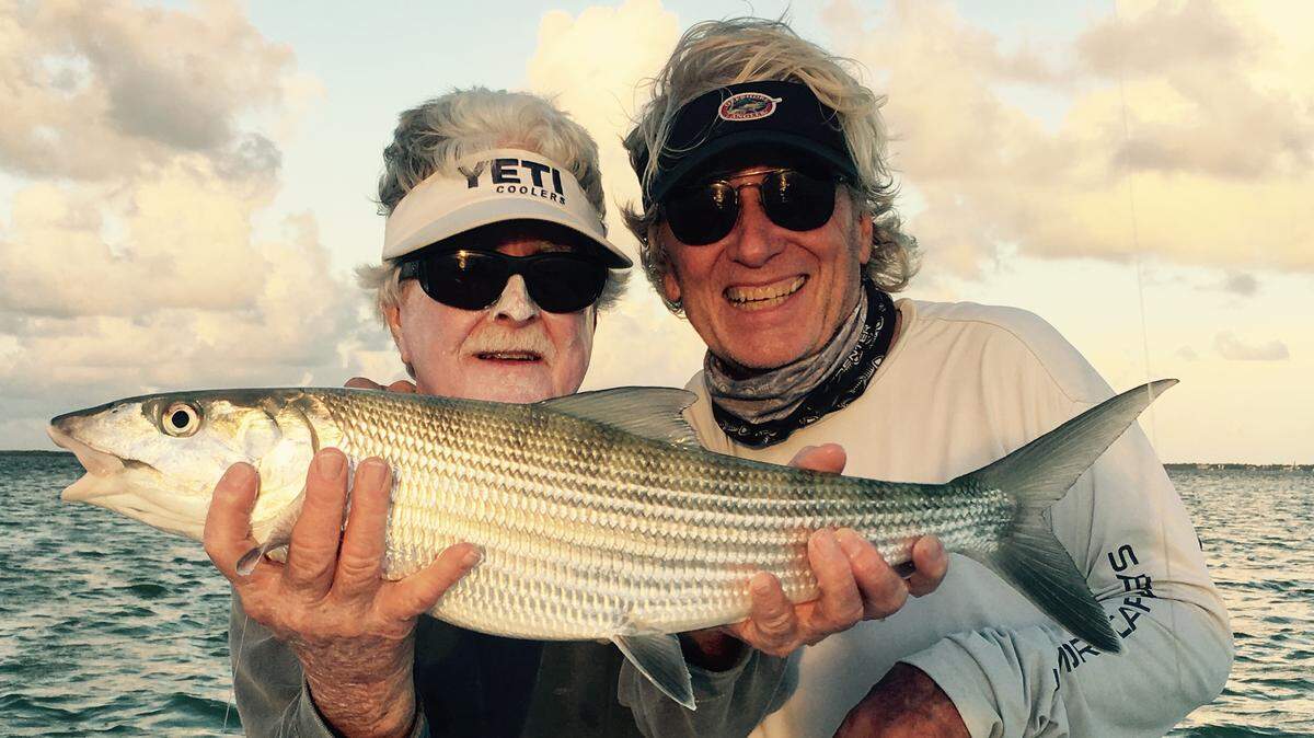 Capt. Richard Stanczyk, left, who fishes out of Bud N’ Mary’s Marina in Islamorada, holds a bonefish caught in Florida Bay by Ron Modra.
