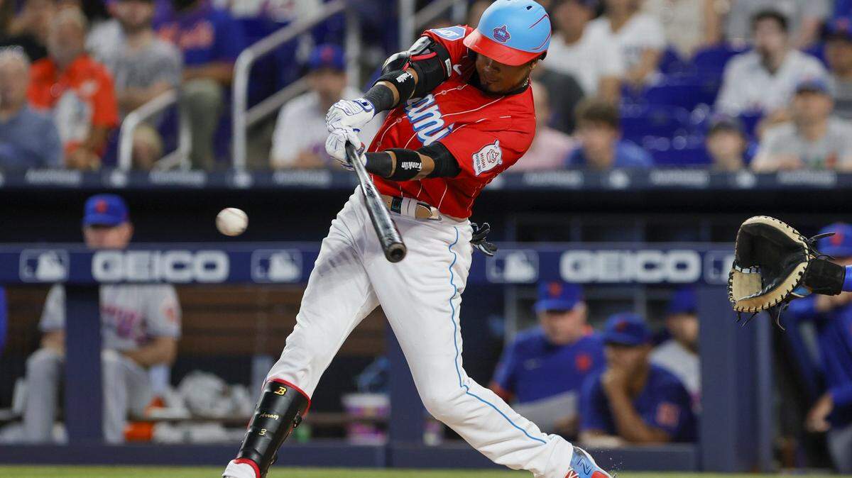 Miami Marlins second baseman Luis Arraez (3) hits a single during the first inning against the New York Mets at loanDepot Park on Saturday, April 1, 2023.