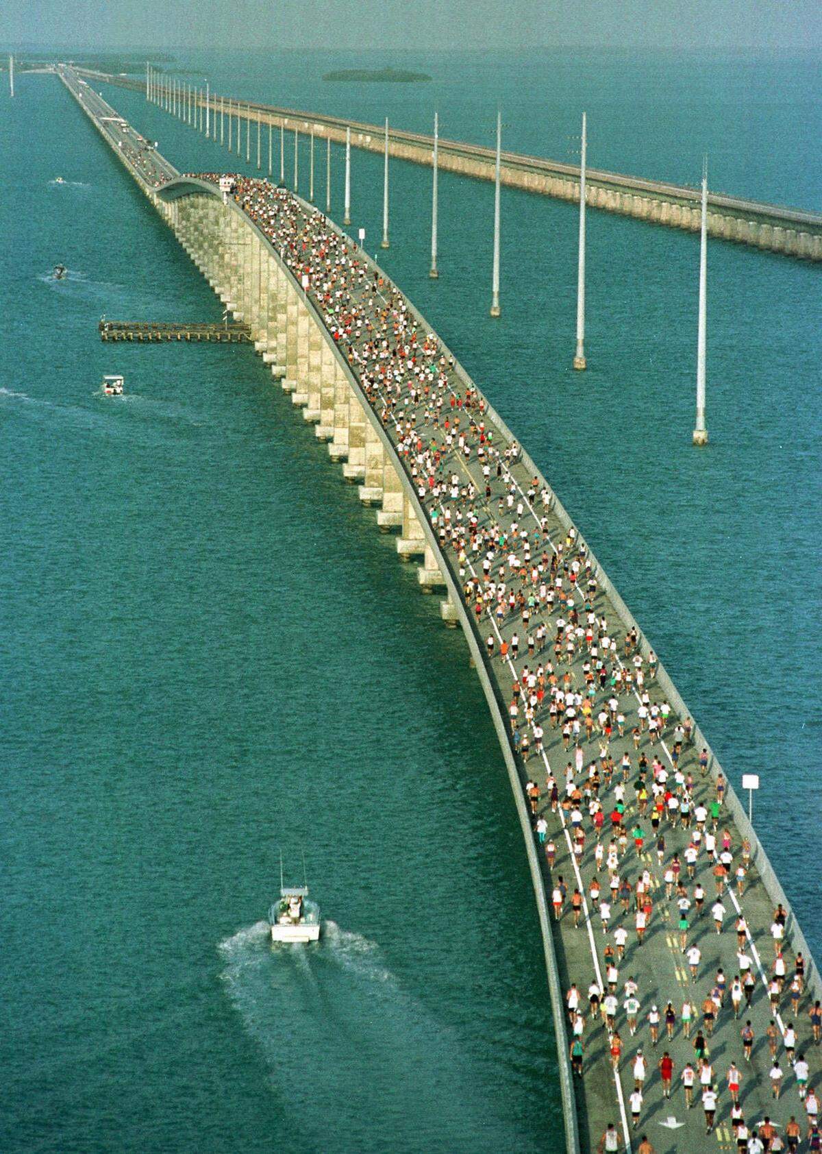With the Atlantic Ocean at left and Gulf of Mexico at right, the main pack of 1,500 runners competing in the 15th Annual Seven Mile Bridge Run in the Florida Keys Saturday, April 13, 1996 approach the highest point of the bridge affectionately known as the “hump.” Roberto Castillo of Miami and Karen Miles of Fort Myers, Fla., were top men and women’s finishers of the annual competition over the longest of 43 bridges that helps make up the Overseas Highway in the Keys.