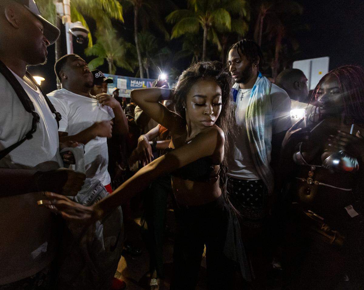 A woman dances on Ocean Drive during spring break on Saturday, March 11, 2023, in Miami Beach, Fla.