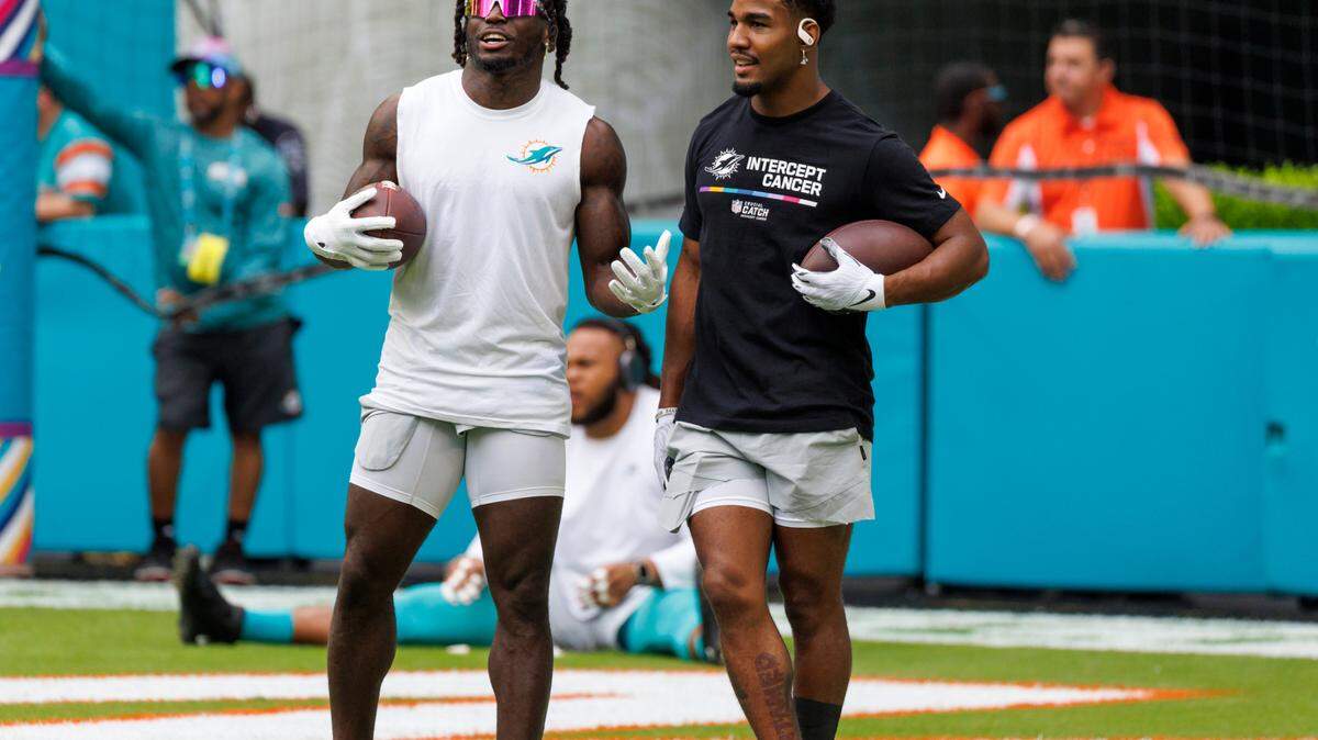 Miami Dolphins wide receivers Tyreek Hill and Jaylen Waddle talks during pregame warmups before the start of an NFL football game against the Minnesota Vikings at Hard Rock Stadium on Sunday, October 16, 2022 in Miami Gardens, Florida.