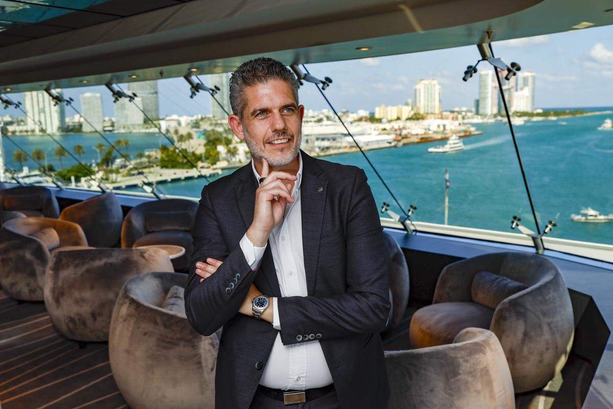 Executive Vice President Neil Palomba views the Miami skyline while visiting the new Yacht Club Top Sail Lounge on the MSC Poesia docked at PortMiami in Miami, Florida, on Wednesday, April 22, 2026. Built in 2008, it underwent refurbishment this year. This winter, it will be based at PortMiami heading on trips to the Caribbean.