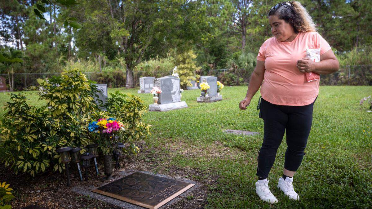 Gamaly Hollis looks back to her son’s grave after she carefully cleaned it on June 17, 2024. Gamaly Hollis is the mother of Richard Hollis, a 21-year-old who was killed by a Miami-Dade police officer on June 15, 2022.