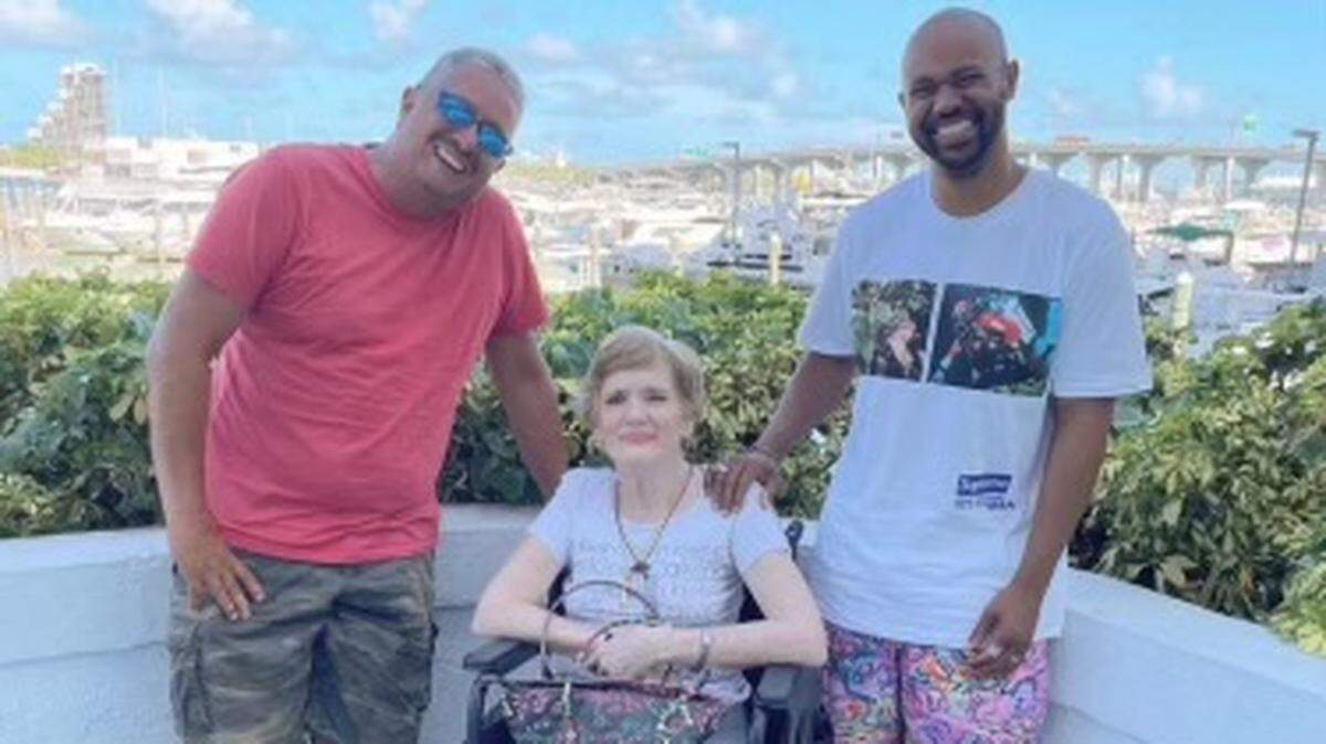 Vivian Hevia with her two sons-in-law.