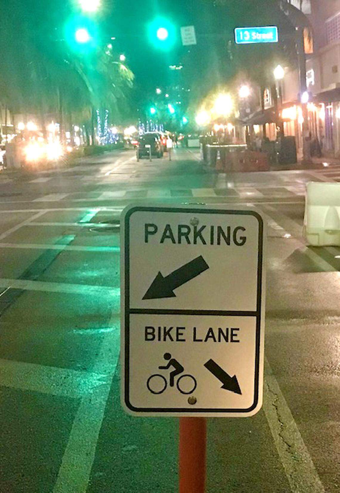 A sign marks the new bike lane protected by a parking lane on Washington Avenue in Miami Beach.